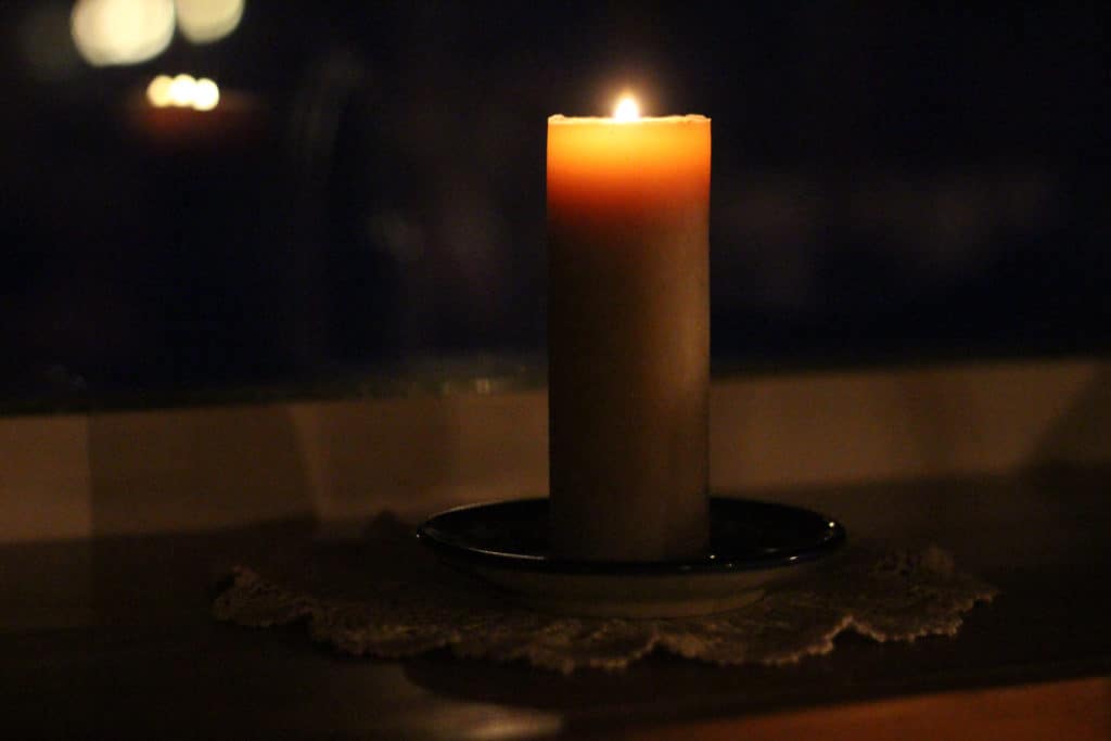 Candle on a windowsill. Staying content during a long winter.