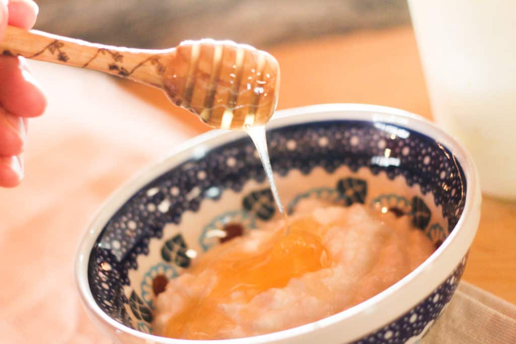 Bowl of homemade yogurt with honey drizzling on top