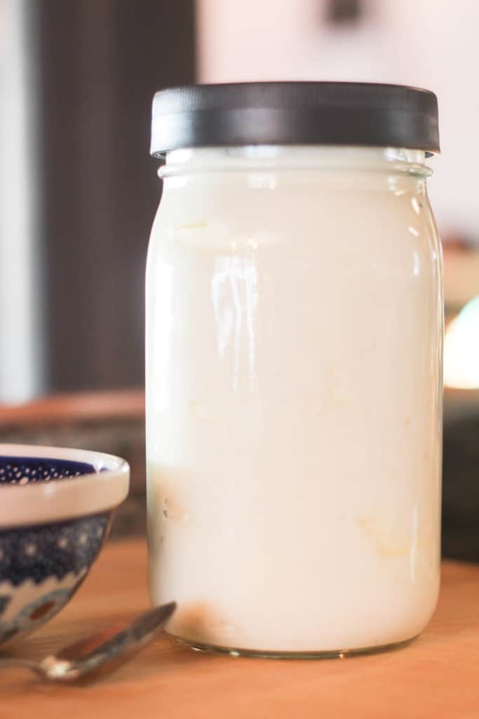 Glass quart jar full of homemade yogurt