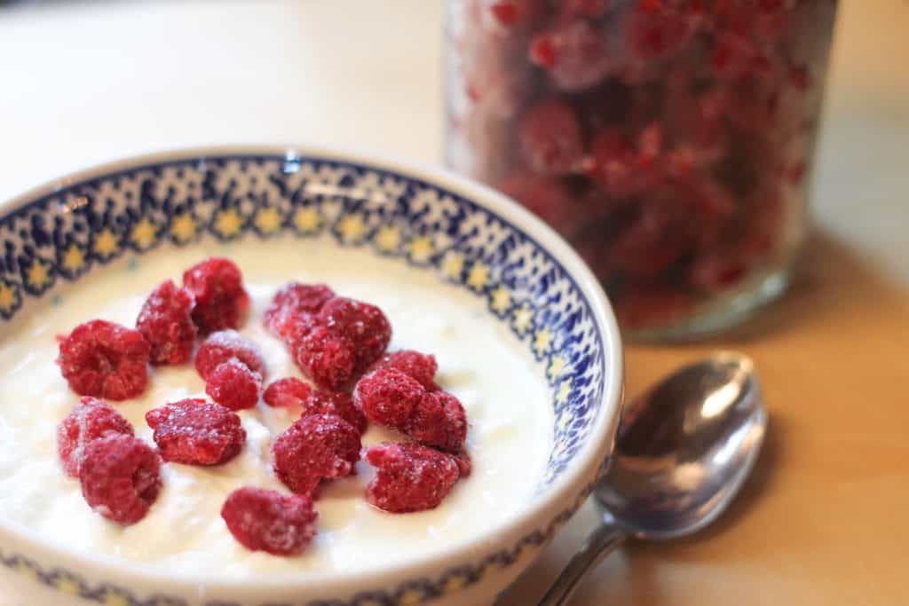 a bowl of yogurt with berries on top