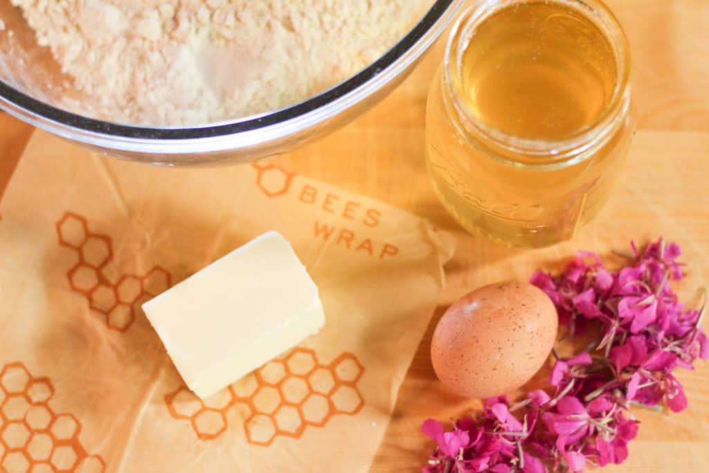 Ingredients for fireweed scones: butter, an egg, fireweed petals, and honey.