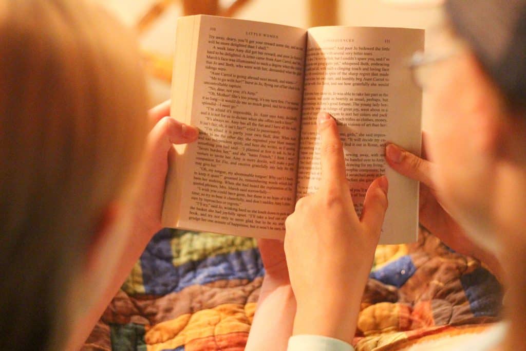 Girls reading a book together