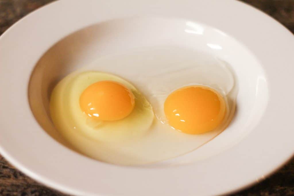 2 egg yolks in a bowl.