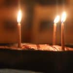 diy beeswax birthday candles in a chocolate cake