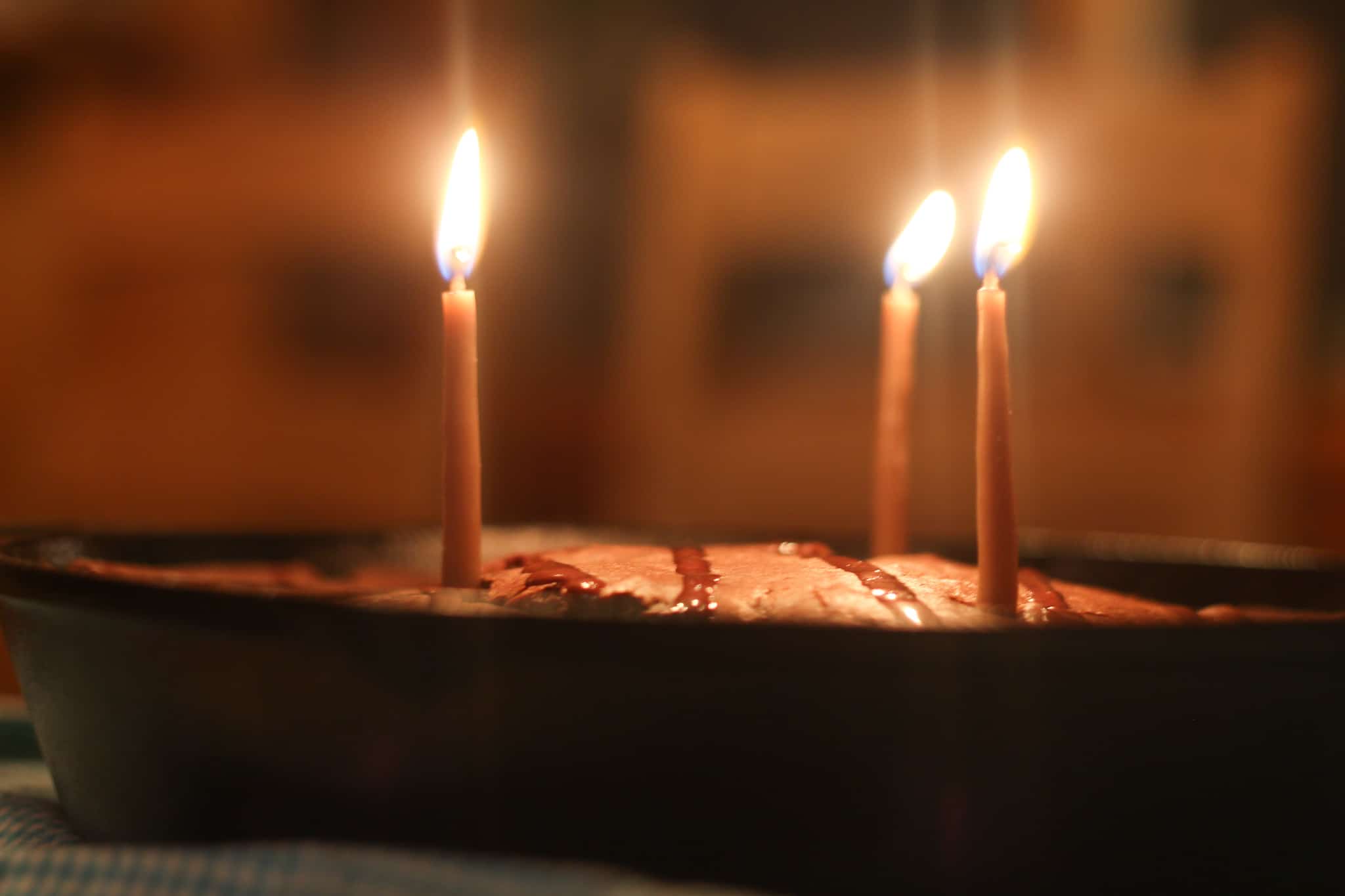 diy beeswax birthday candles in a chocolate cake