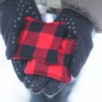 Hands wearing gloves holding a handmade hand warmer