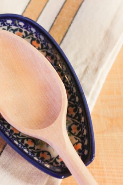 A wooden spoon on a spoon rest