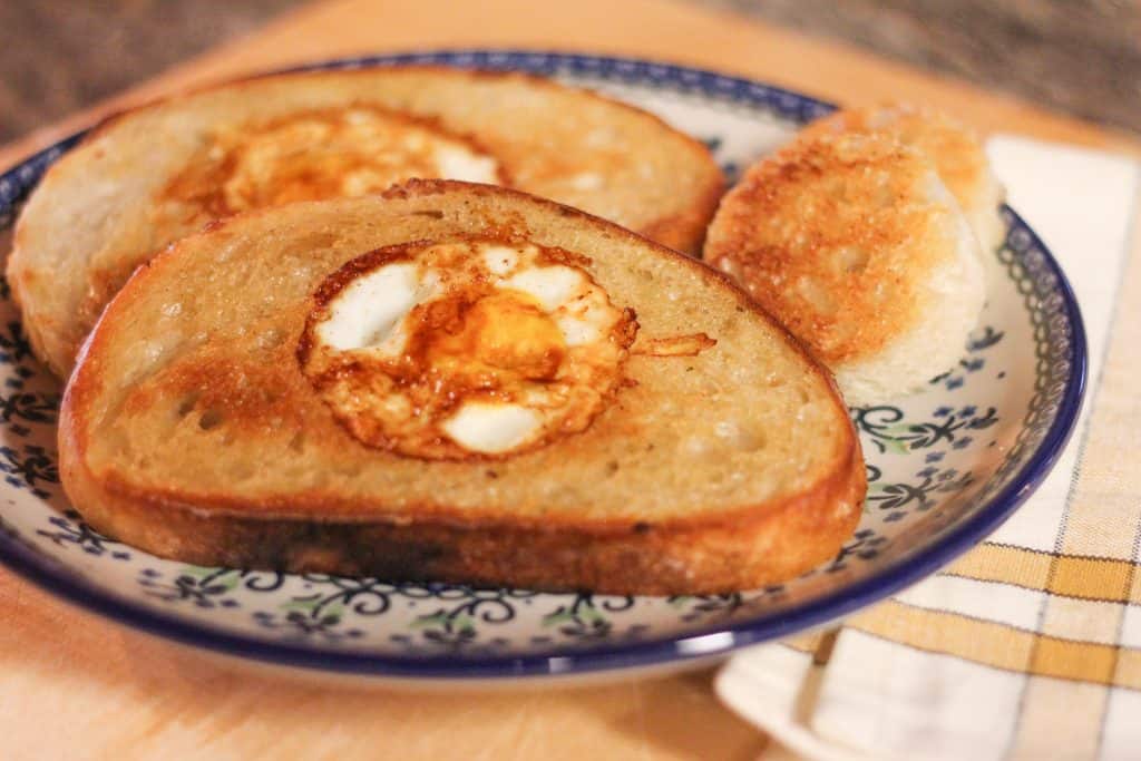 Eggs in a basket, or toast with an egg in the middle, sitting on a plate