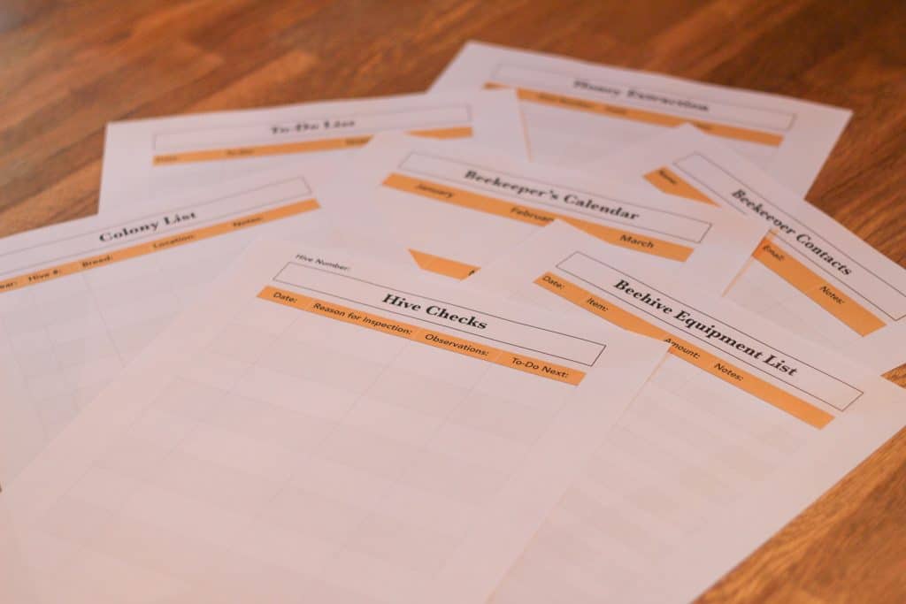 Several pieces of paper of printable beekeeping records