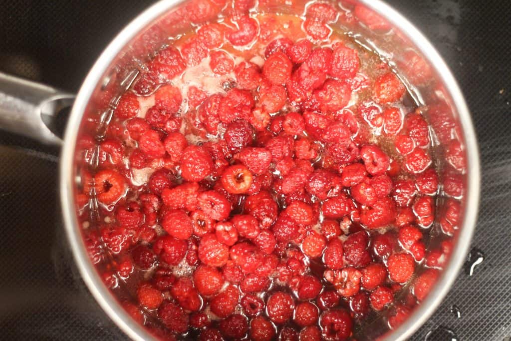Raspberries boiling in a pot