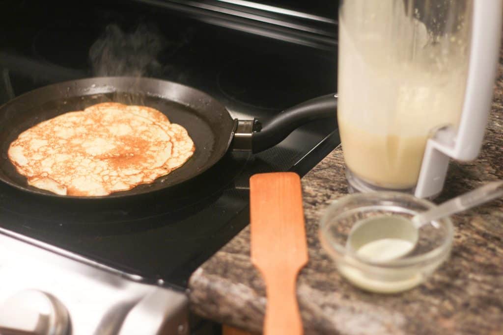 A crepe cooking on a pan on the stove