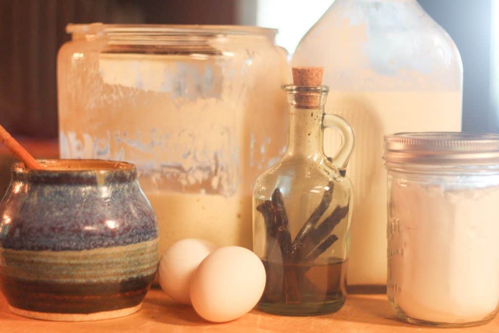 Ingredients for crepes-eggs, vanilla, milk, sourdough, honey