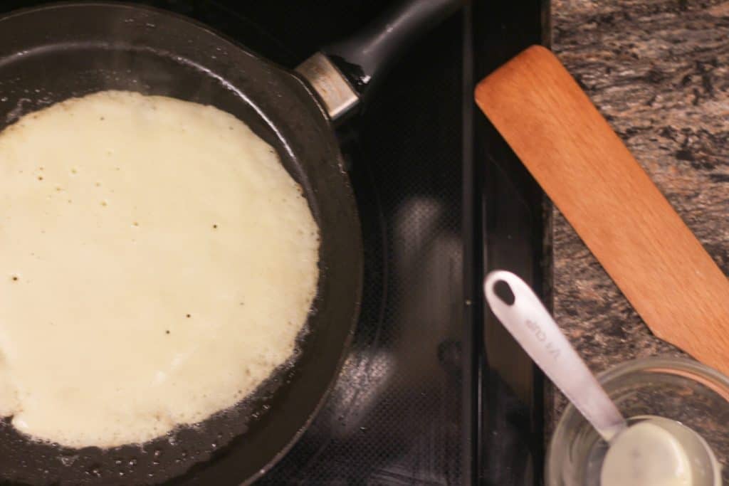 A crepe cooking on a pan