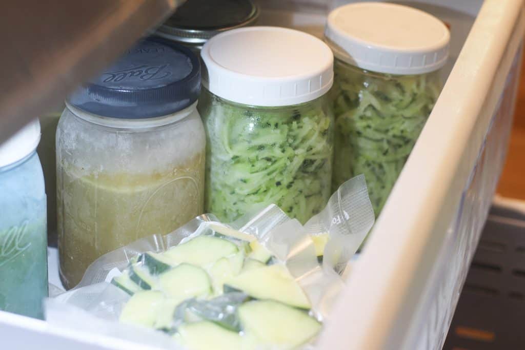 A freezer with frozen zucchini