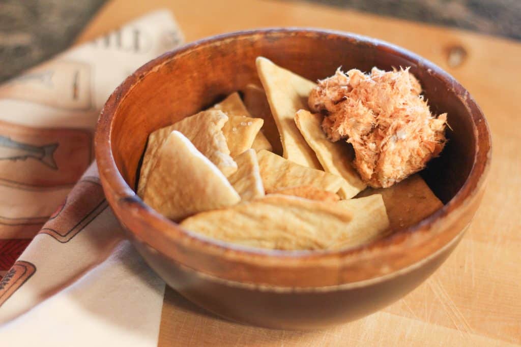 A bowl of crackers with some smoked salmon
