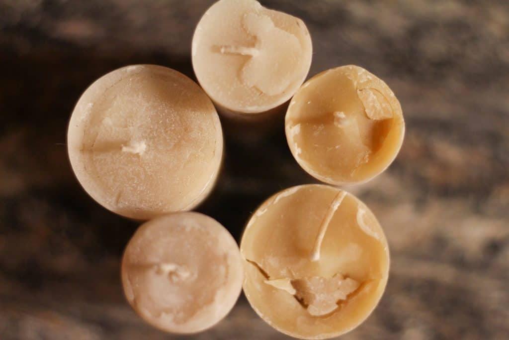 Overhead view of 5 pillar beeswax candles, benefits of beeswax candles