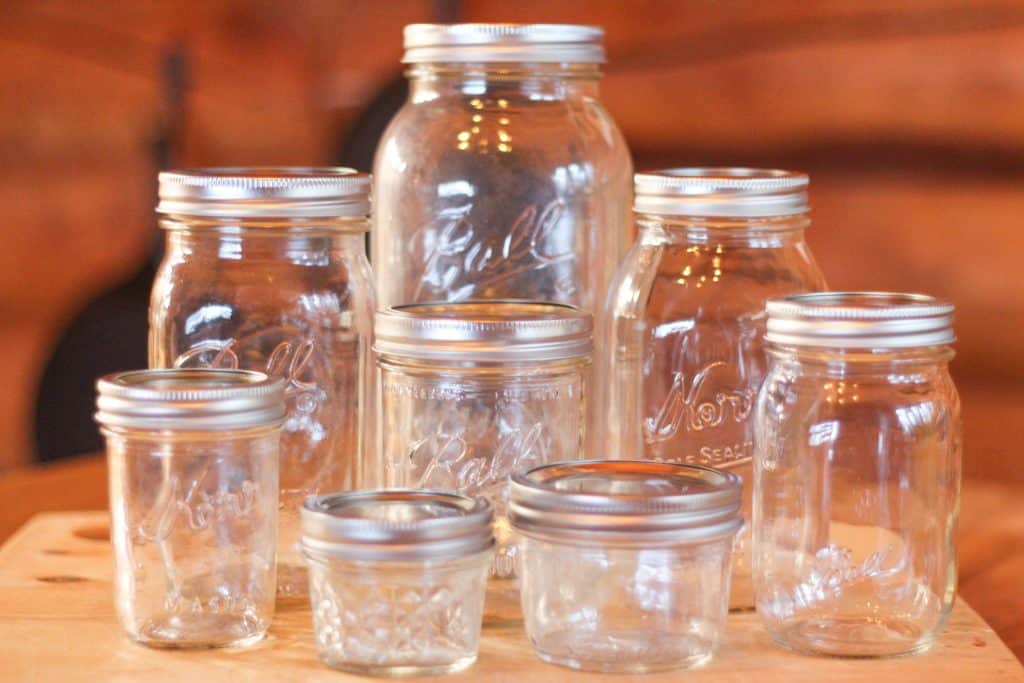 Several empty glass jars showing the sizes of canning jars