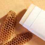 Stick of body butter with beeswax and pieces of beeswax