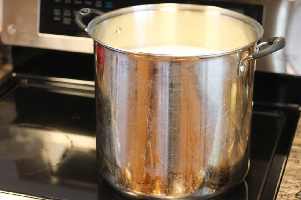 A large pot full of milk for making cheese