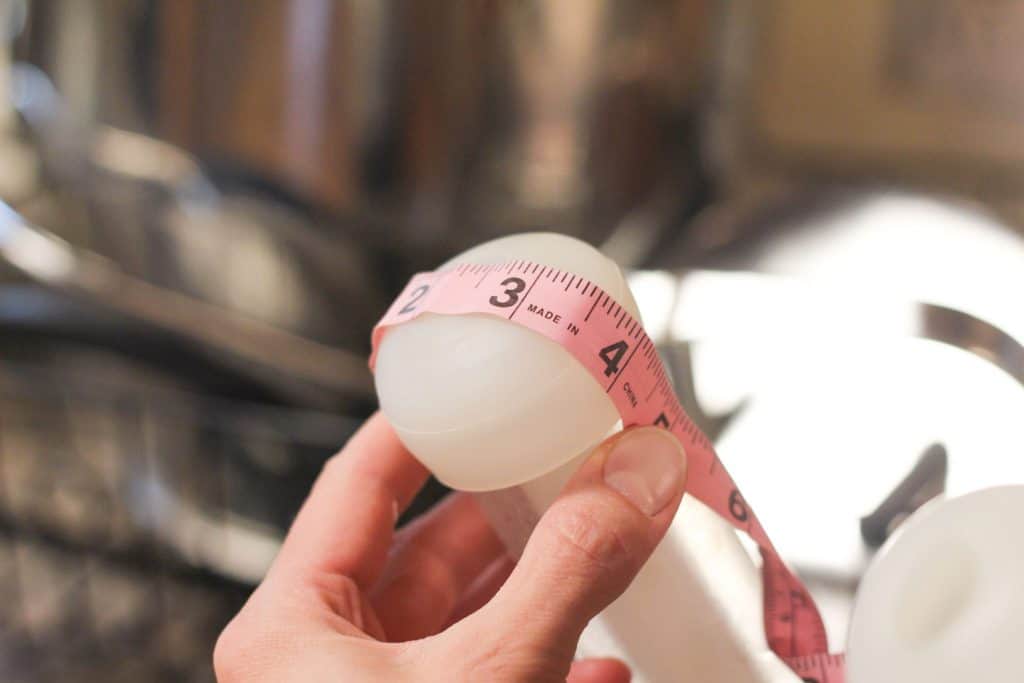 Using a tape measure to measure a milk inflation