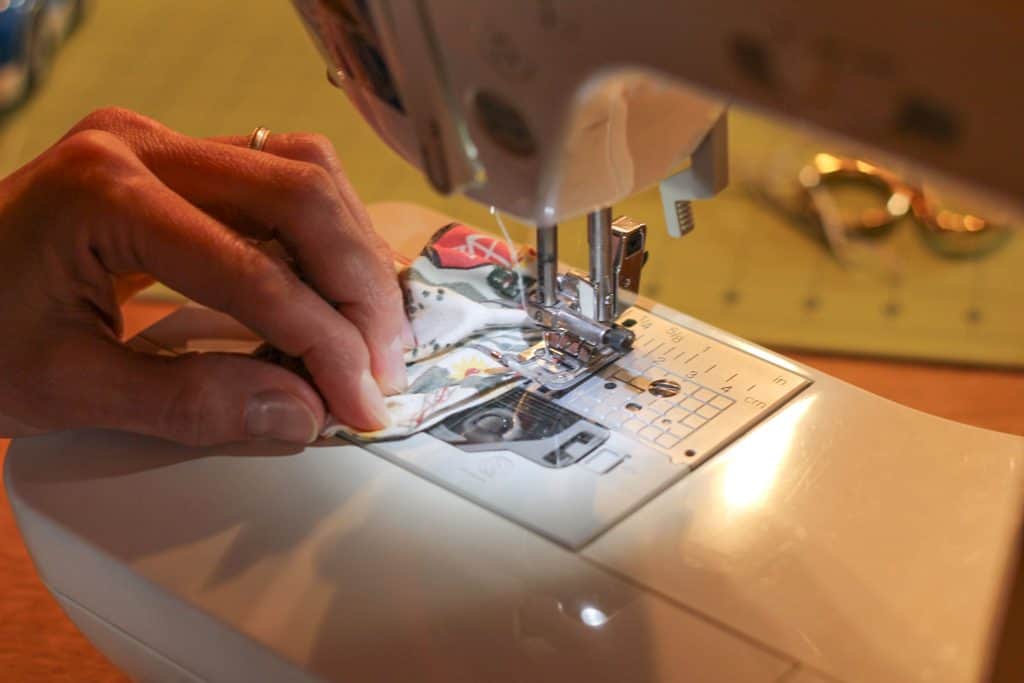 A sewing machine stitching fabric together