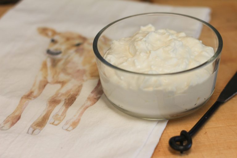 Homemade cream cheese in a glass container
