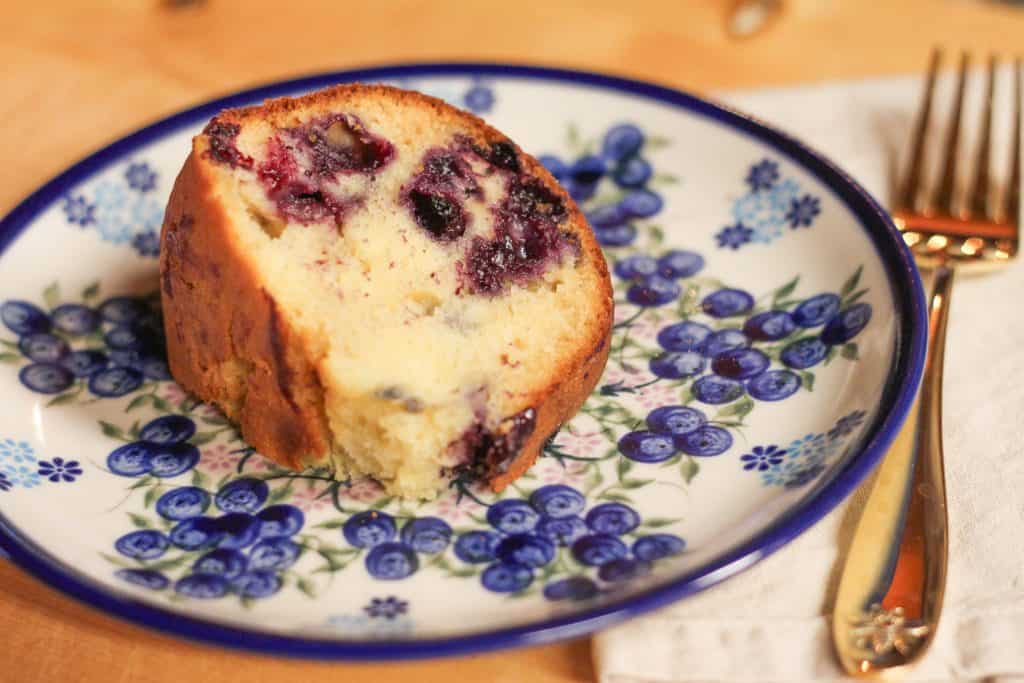 A slice of blueberry bundt cake on a plate.