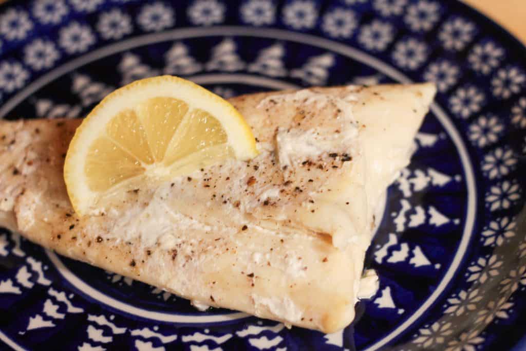 A piece of cooked halibut on a plate