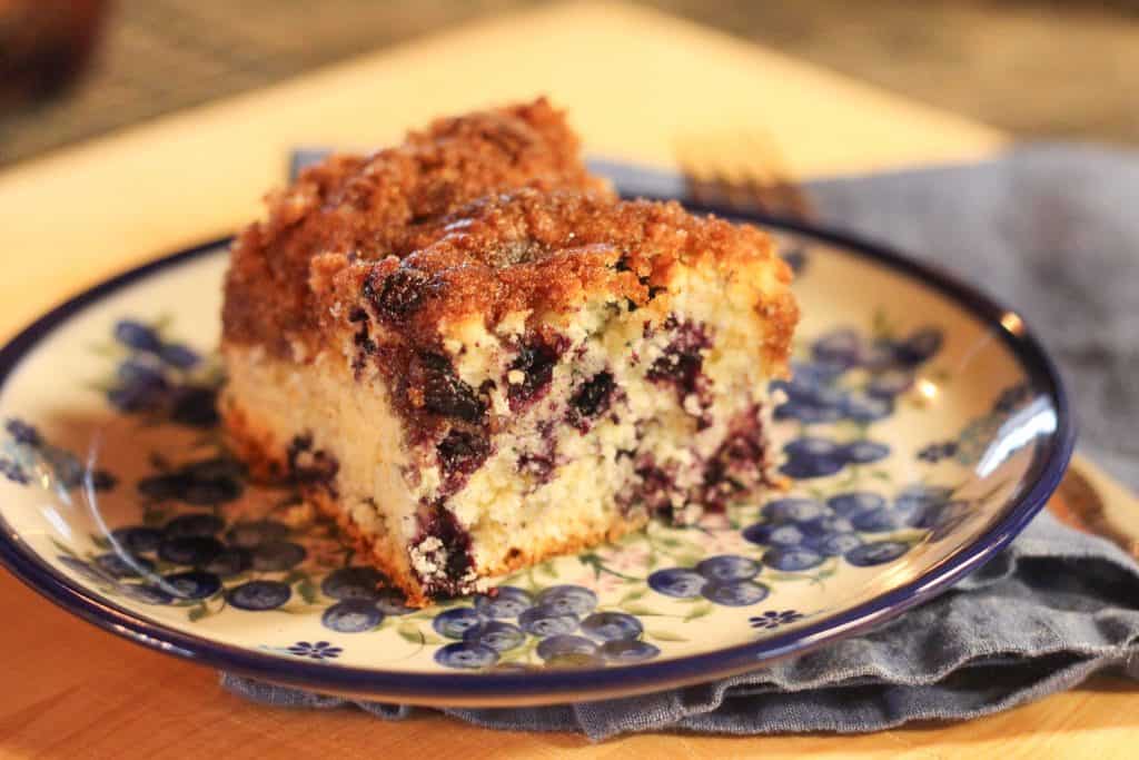 A piece of blueberry coffee cake on a plate