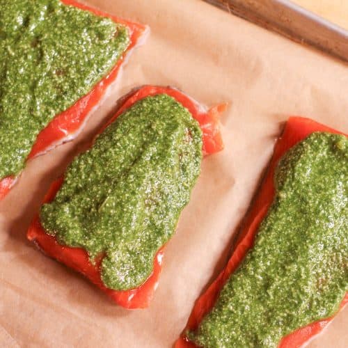 3 salmon fillets with homemade pesto spread on them